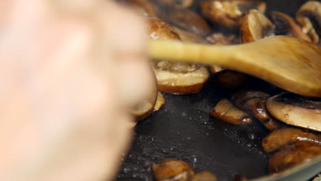 sliced mushrooms cook in a pan