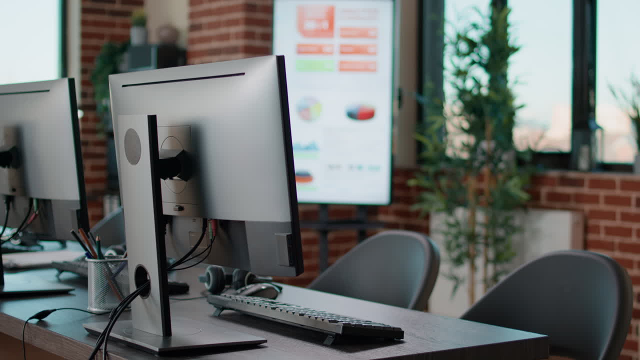 Empty startup office with computers on desk at workstation