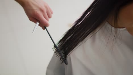 handheld video shows of hairstylist cutting hair his customer