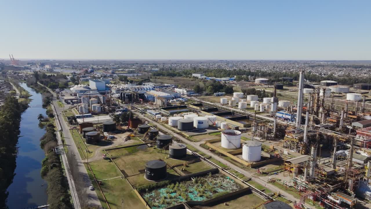 Industrial area with oil refinery and tanks, suburban neighborhood visible