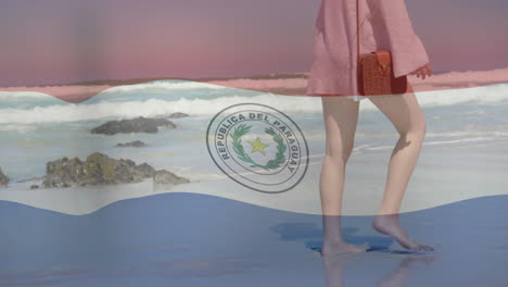 paraguay flag animation over woman walking on beach with waves in background