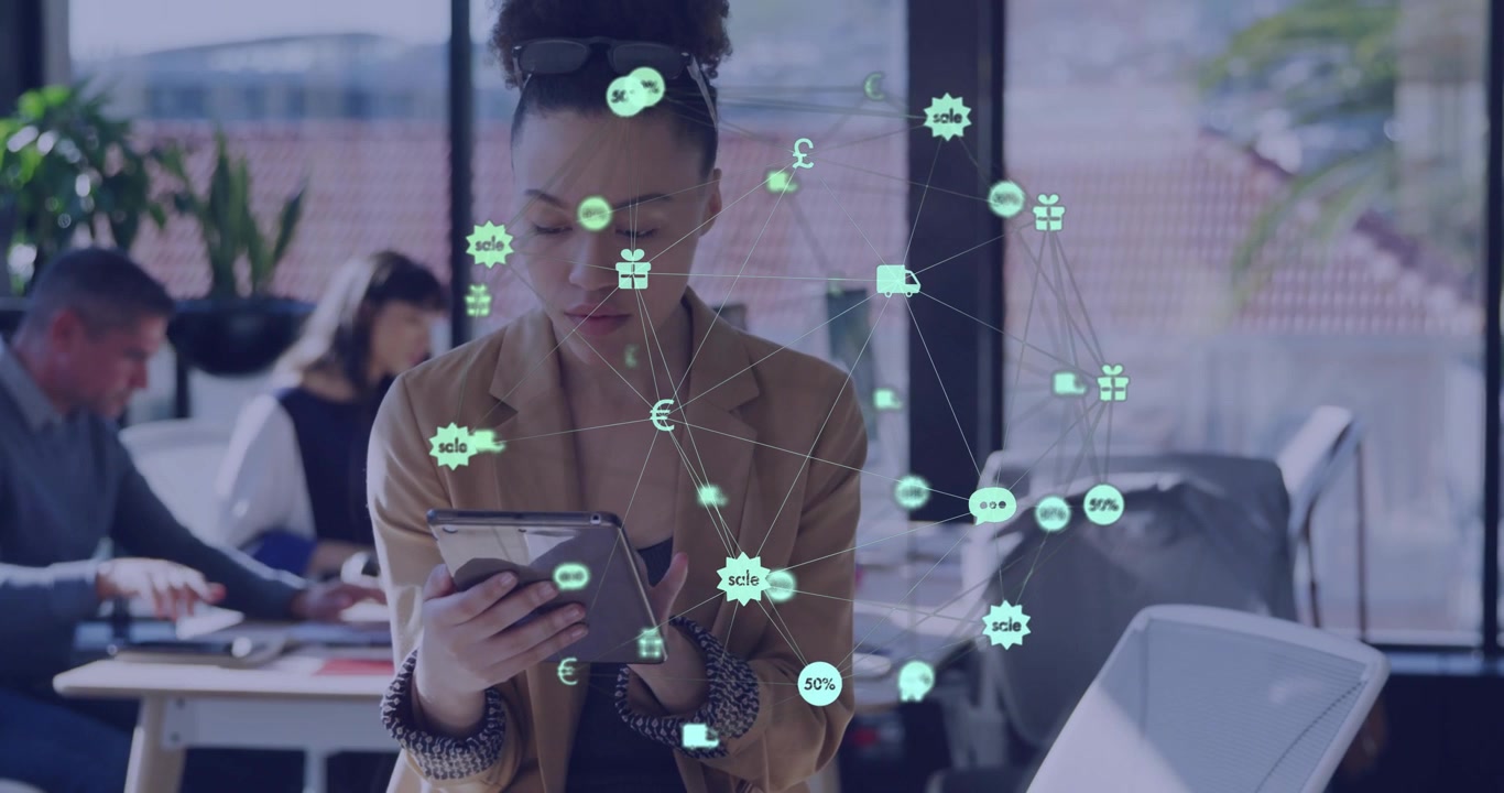 Woman holding tablet tapping in open business office, reviewing orders, making icons cluster