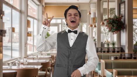 Happy-Indian-waiter-showing-victory-sign