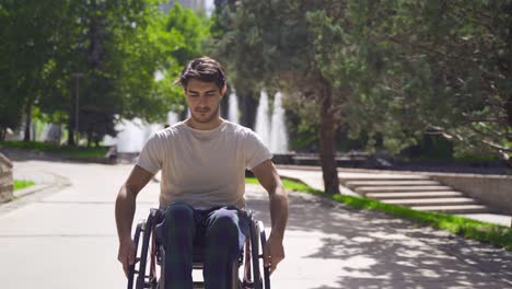 young disabled man walking down the street with his wheelchair.