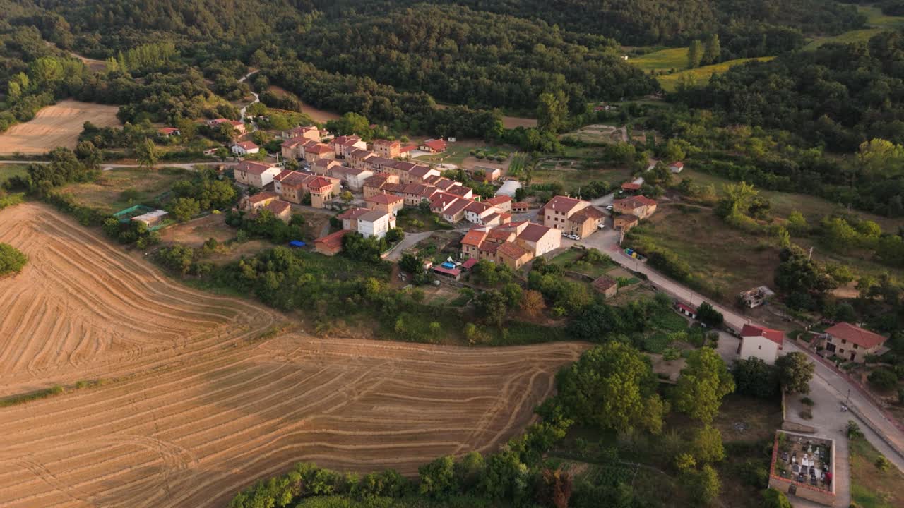 Approaching drone shot of a village in the midst of an agricultural landscape in a Spanish countryside in Valderrama, Spain.