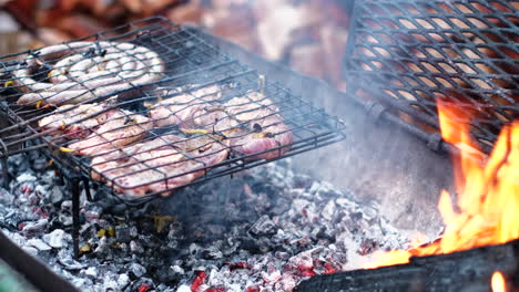 grilling mutton chops and traditional south african sausage on hot coals of fire