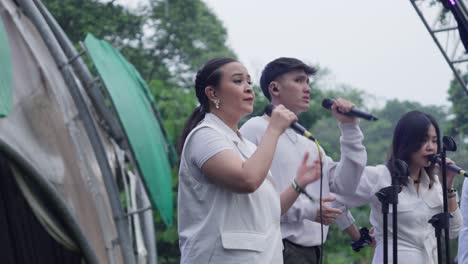 musicians prepare for a live performance outdoors at kebun raya bogor during the sunset concert