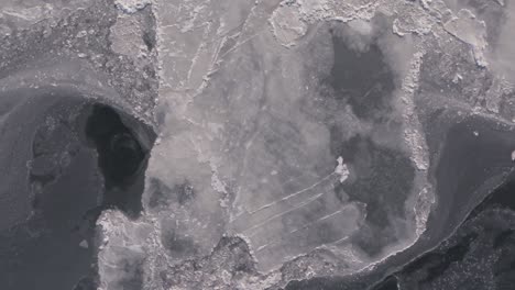 aerial view of the frozen waters along the edges of the hudson river in new york.