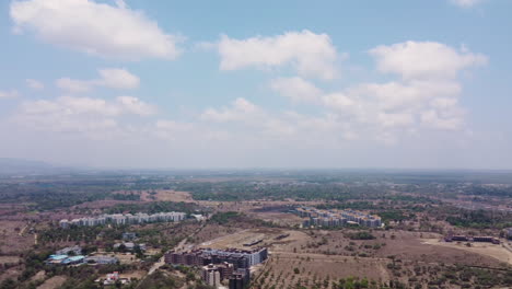 Aerial-hyper-lapse-of-white-fluffy-clouds-passing-above-the-town