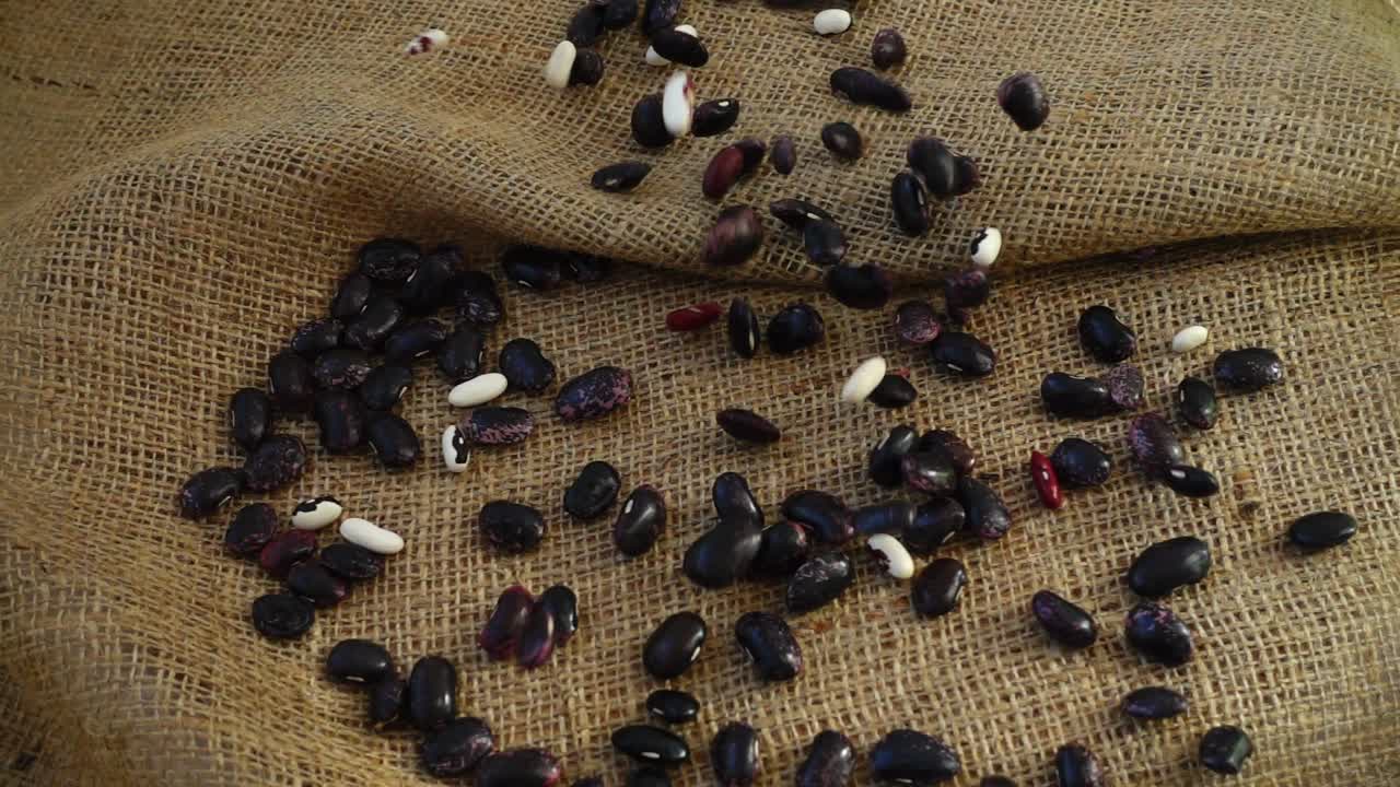 Falling of haricot on burlap. Slow Motion. . Slow Motion