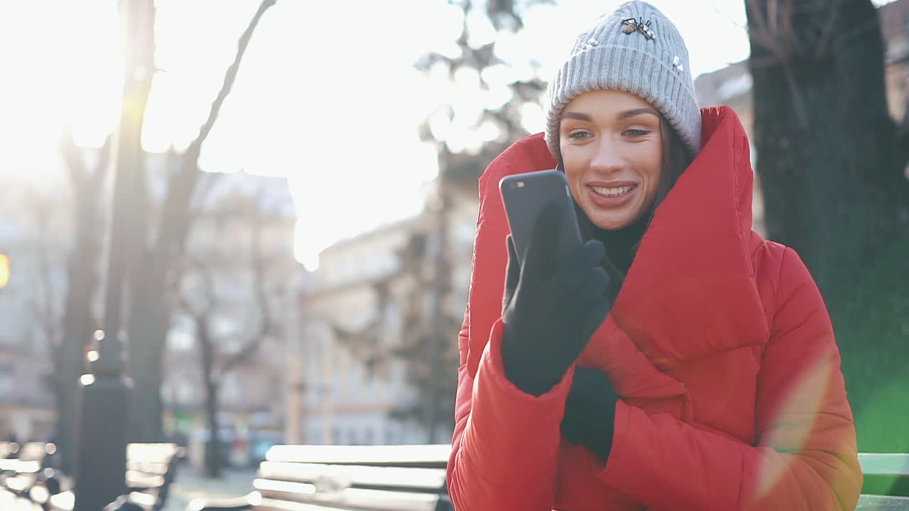 Woman using phone outdoors in winter