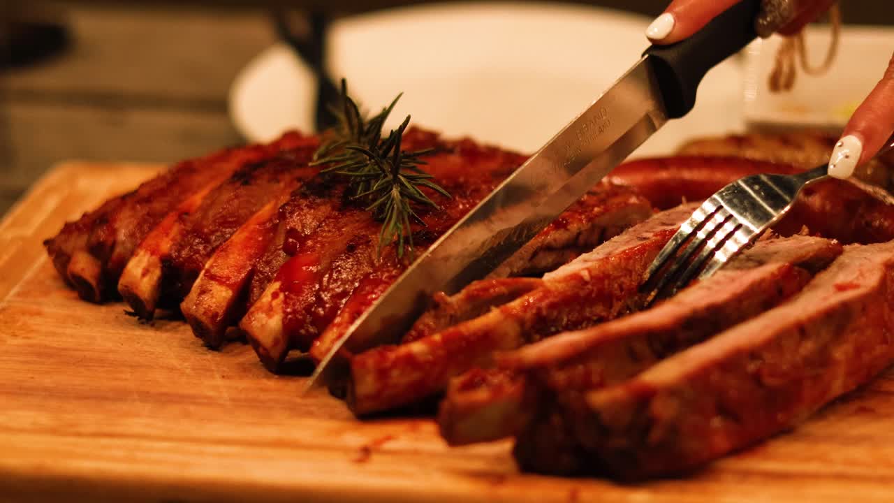 Carving juicy ribs on a wooden board