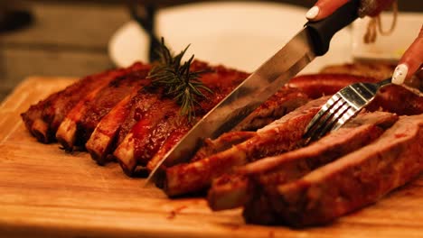 carving juicy ribs on a wooden board