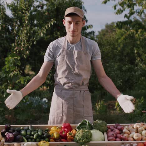 proud young farmer at the counter with vegetables from his field