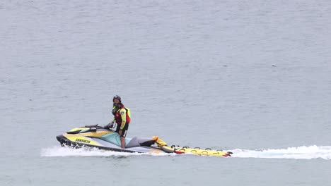 person riding a jet ski across a lake