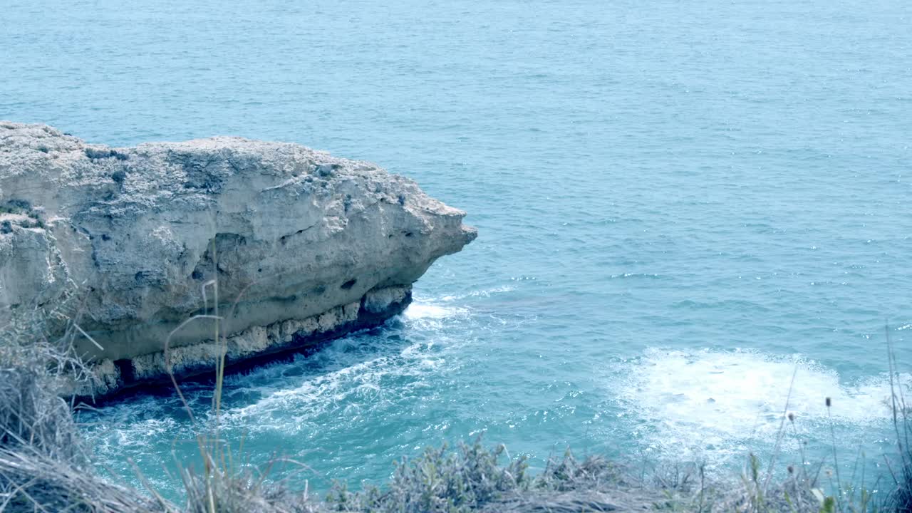 Rocky Cliff Face on a Blue Ocean Coast