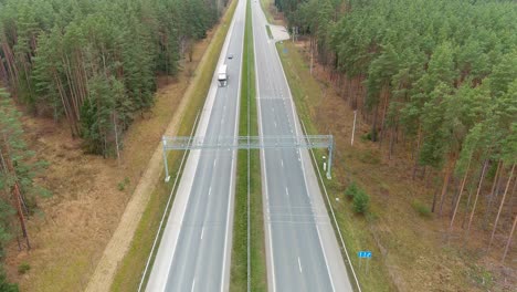 Cars-driving-bellow-speed-radar-in-highway-road,-aerial-view