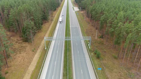 cars driving bellow speed radar in highway road, aerial view