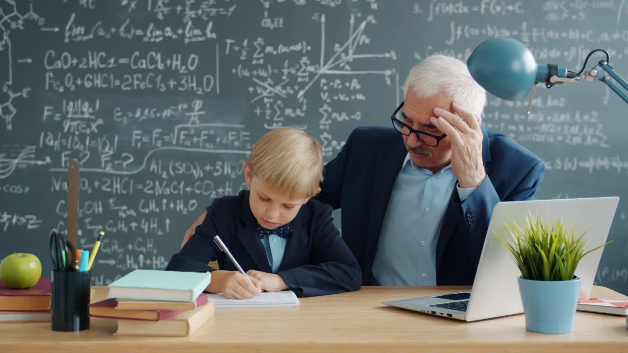 Teacher helping student with homework in classroom