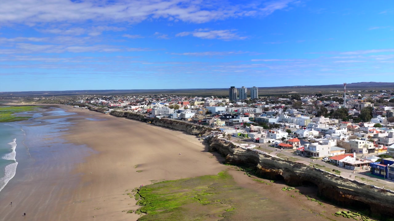 Wet tidal sands curve along the shoreline of Las Grutas, a beach town on the Patagonian coast of Argentina.