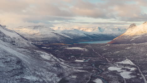 4k drone time-lapse with forward zooming motion at norwegian mountains in a lush arctic winter landscape during sunset