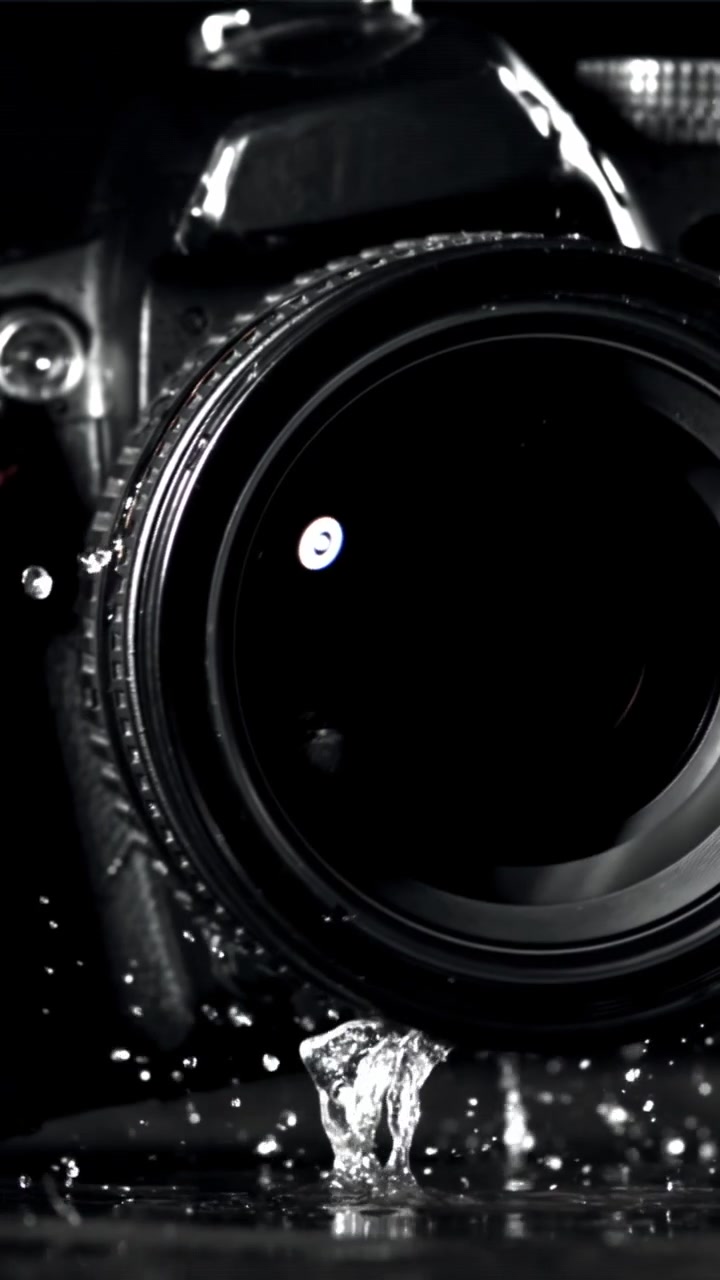 Slow Motion Water Drops Splashing on a DSLR Camera Lens