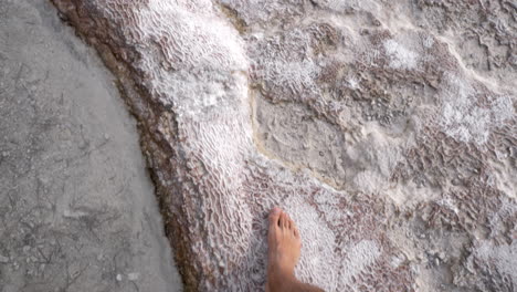 Man-walking-on-travertine-terraces-in-Pamukkale-Turkey