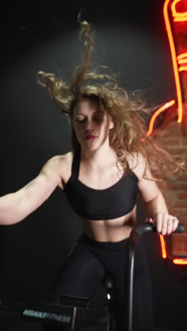 woman exercising on a spinning bike in a gym