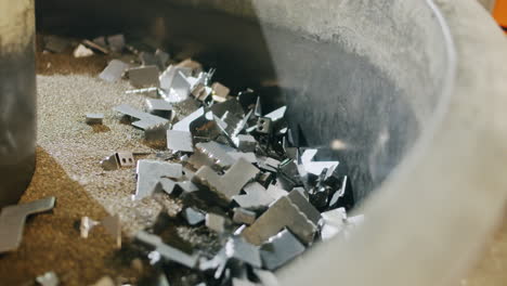 metal car parts being cleaned and sanded after coming from an automated production line factory