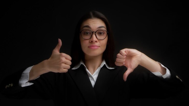 Woman raises and lowers her thumbs can't choose between like or dislike