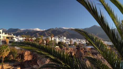 View-in-between-Palm-trees-toward-white-villas-and-mountains