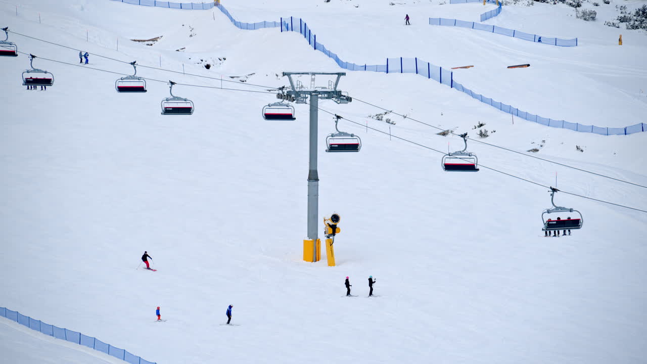 Distant view of people skiing at a ski resort near a ski lift in Dolomites, Italy