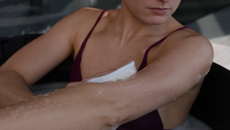 Woman washing her arm in a spa