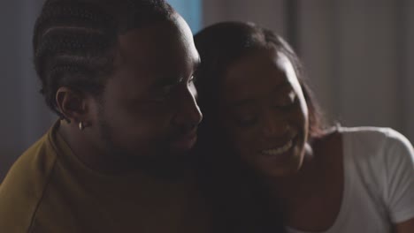 Close-Up-Of-Loving-Couple-Relaxing-At-Home-Sitting-On-Bed-At-Night-Talking-Together-1