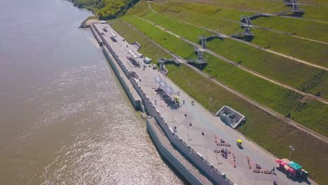 couple walks along waterfront near cascade hill aerial view