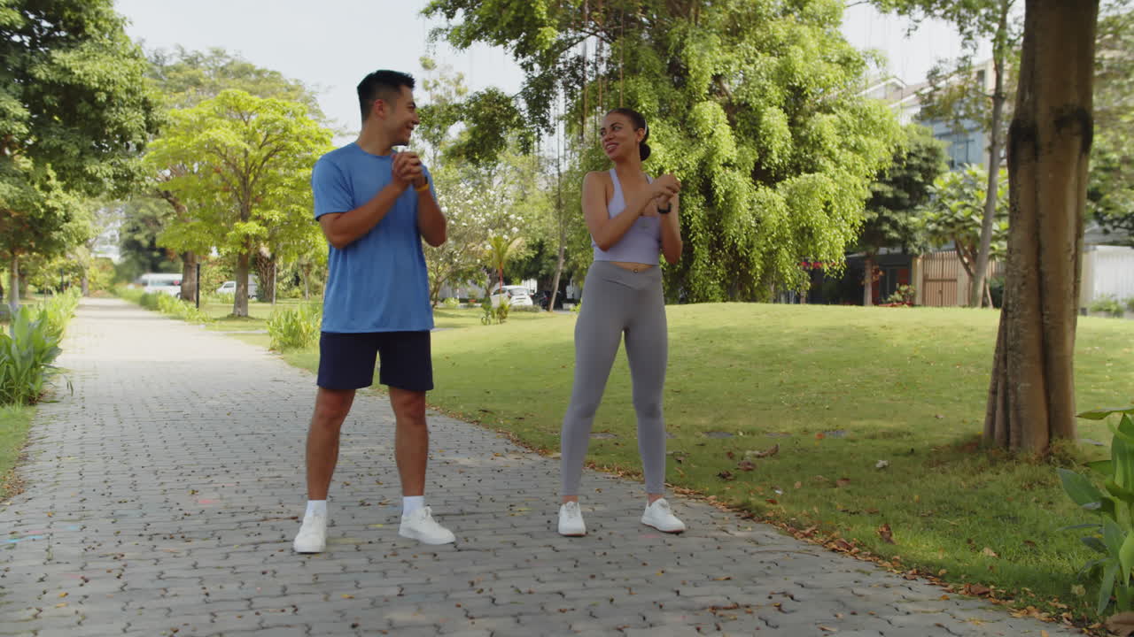 Sportspeople Doing Warm Up when Visiting Park Together