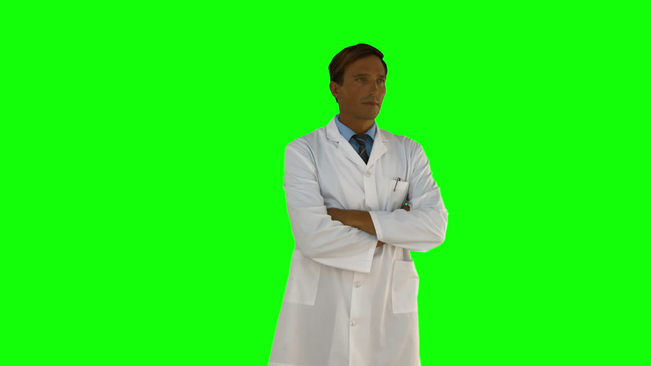 Serious doctor standing with arms crossed