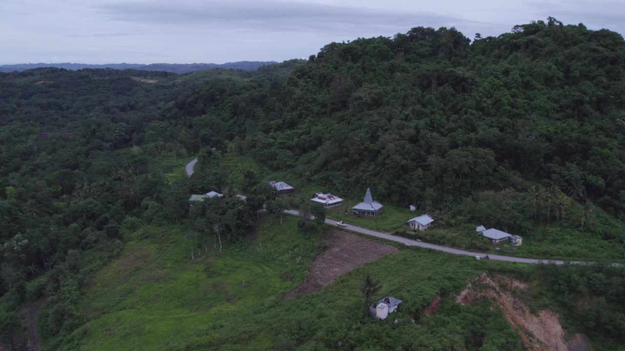 Small local village with road in the countryside of Sumba island, aerial