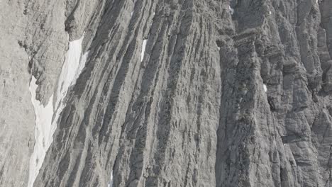 steep rocky cliffs with patches of snow in beaverhead park, british columbia, canada. - aerial closeup shot