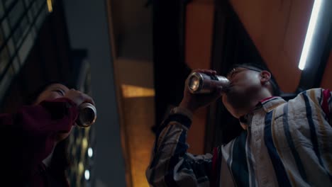 friends toasting with drinks in the city at night