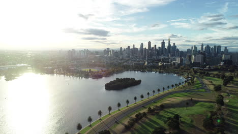 smooth pan and decent over the albert park lake showing melbourne cbd under glorious bright light