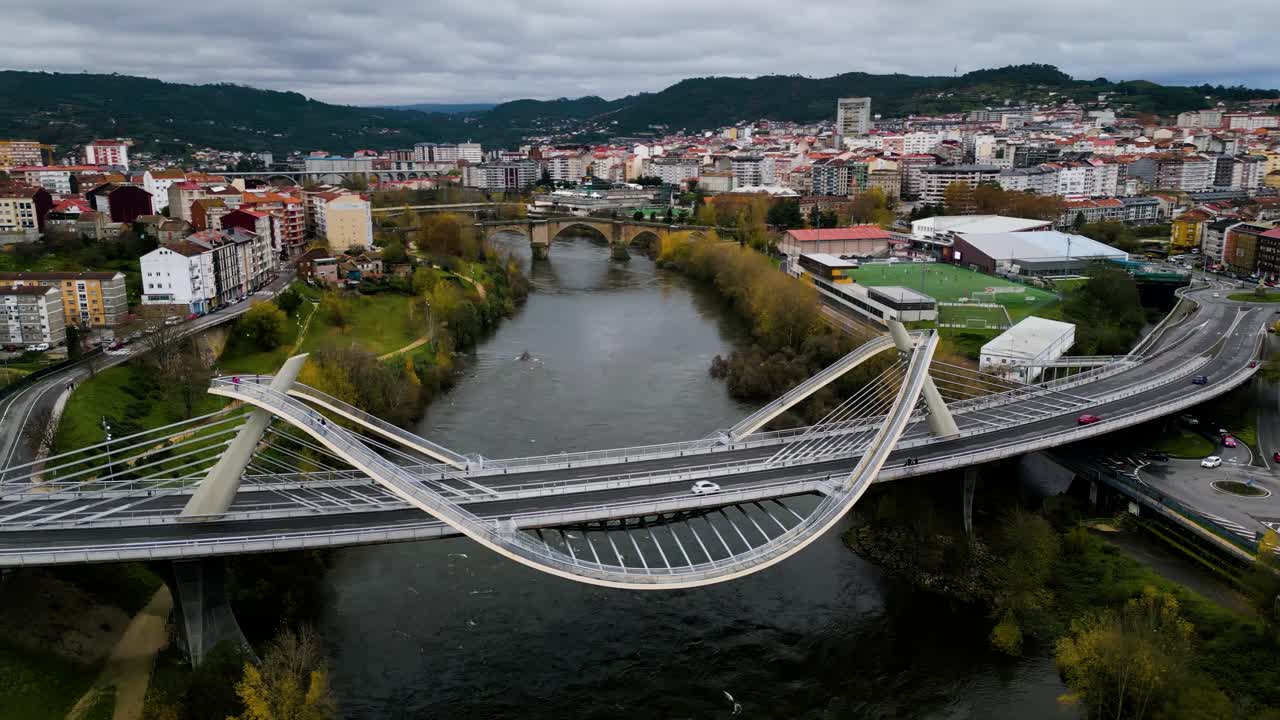 Millennium Bridge Mi&ntilde;o River in Ourense, Galicia, Spain with Roman bridge behind