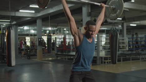 an athletic african american man in the gym.