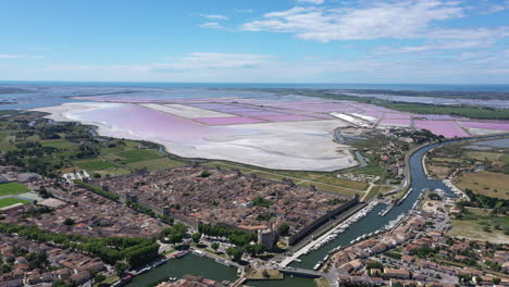 pink saltworks aerial shot over medieval city of aigues-mortes france occitanie