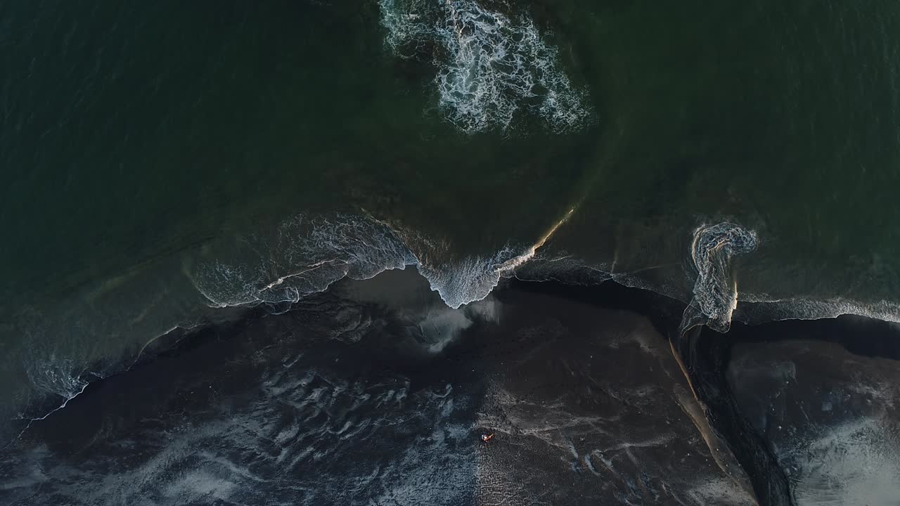 Waves of the sea on the sand beach, drone