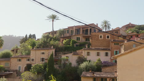 a panoramic shot of deía, mallorca, spain, basking in the sun, showcasing the beauty of the locale