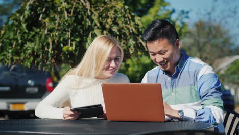 man and woman with tablet and laptop