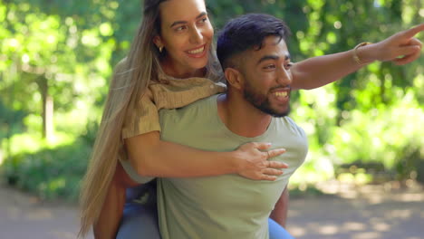 love, jump and piggy back for couple in park