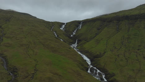 oyggjarvegur mountain, faroe islands: aerial view traveling in distance to the waterfalls of this great mountain, near the kaldbaksfjørður fjord and a spectacular landscape