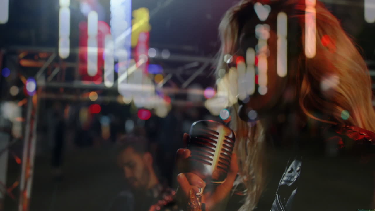 Singer holding mic while guitarist strumming on music concert stage, with animated soundwaves